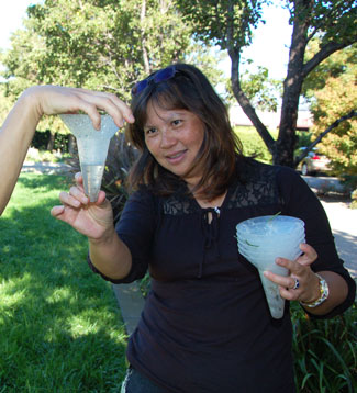 Environmental Compliance Inspector II-Clean Water Florence Khaw inspects recycled water in a container.