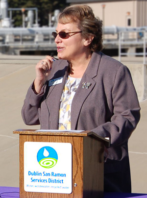 Director Georgean Vonheeder-Leopold speaks at a lectern for a water recycling event.