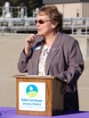 Director Georgean Vonheeder-Leopold speaks at a lectern for a water recycling event.