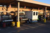 Fleet vehicles are charged under a parking structure.