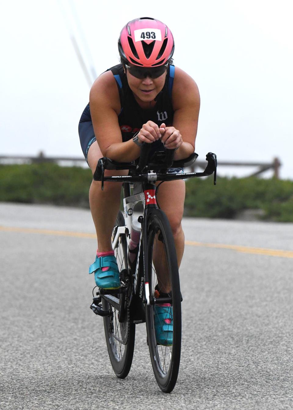 Irene Suroso on a bike in a triathlon, riding toward the camera