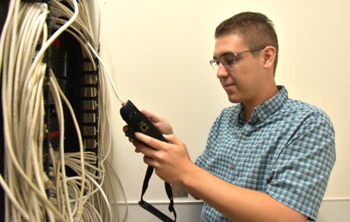 Zack Ruiz tests network connectivity with a handheld scanner.