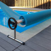 Thumbnail image of pool cover being stretched over pool