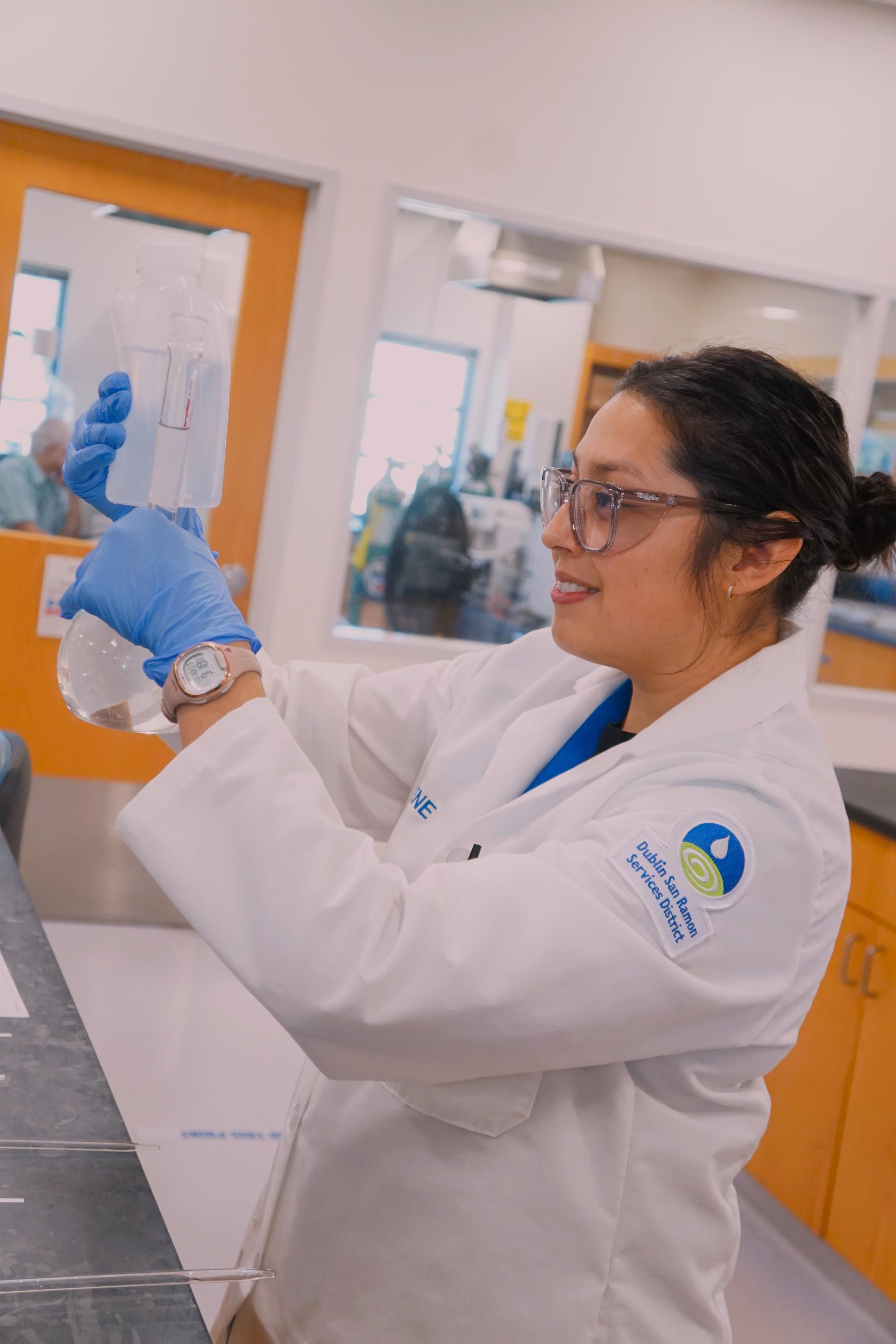 Irene Ceballos measures volume using lab equipment