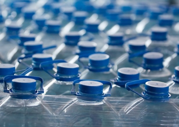 dozens of sealed quart-size bottles of water