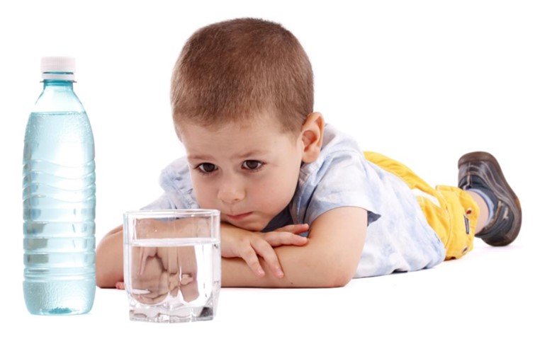 Young boy with bottle and glass of water